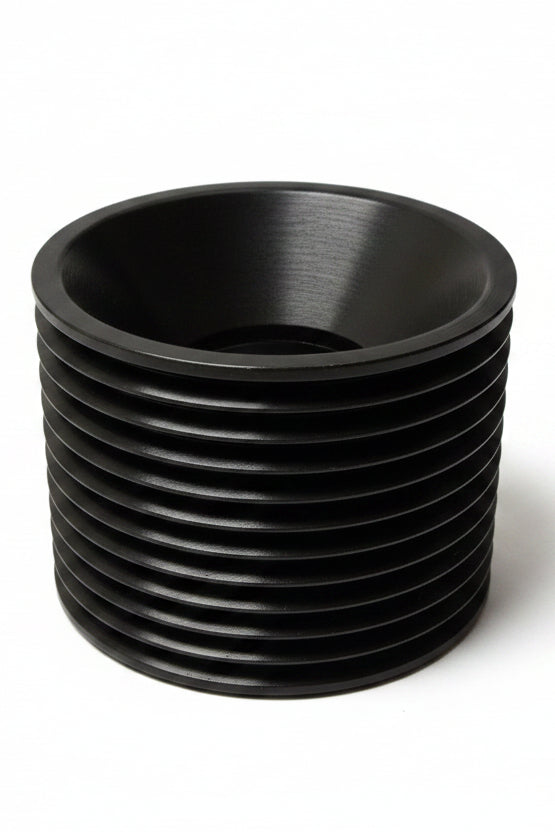 Black cylindrical metal tensioner with multiple horizontal grooves and a hollow center.